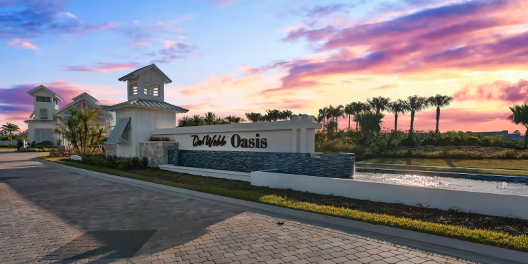 del webb at oasis entrance sign with purple sky